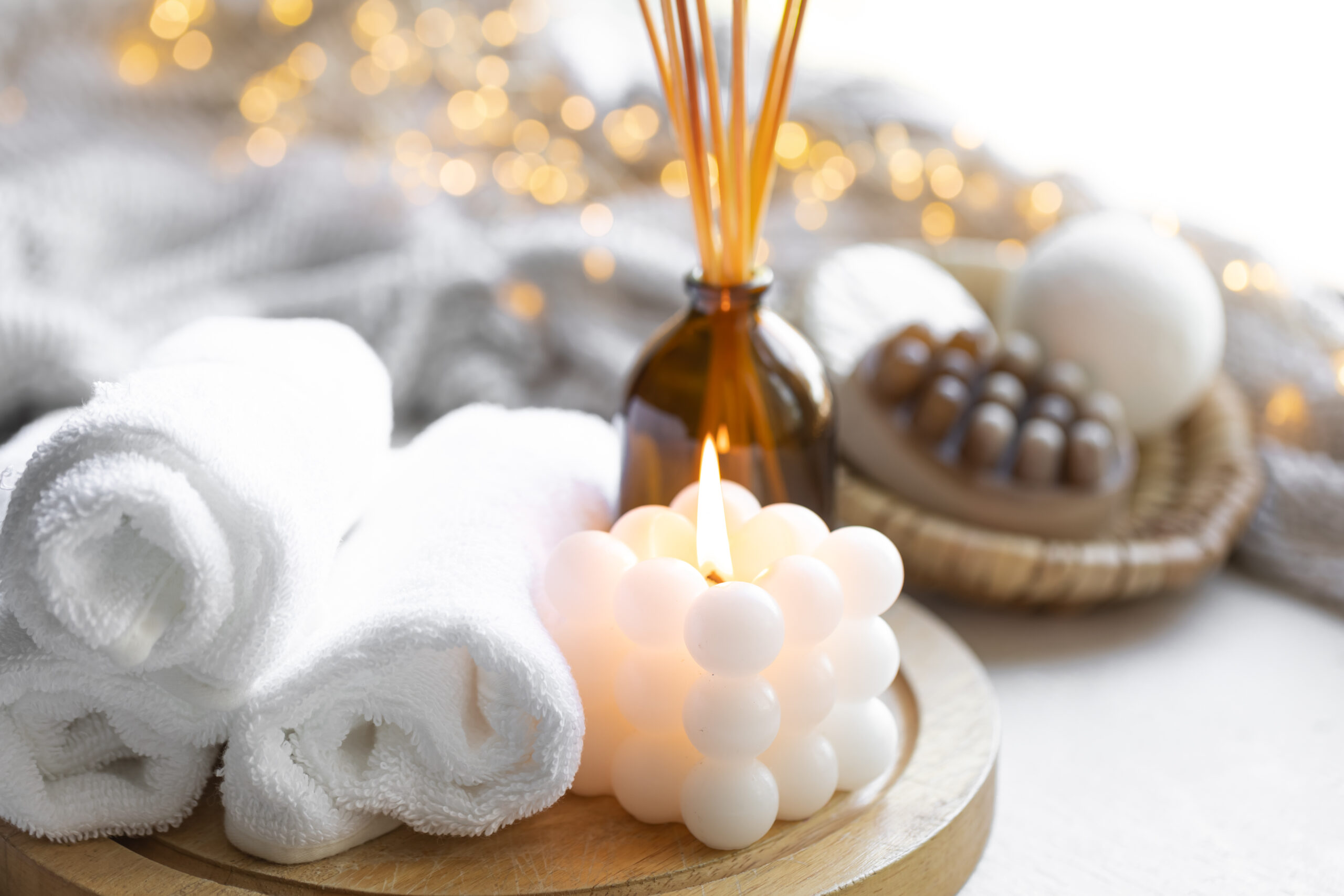 Christmas spa composition on a blurred background with bokeh lights.